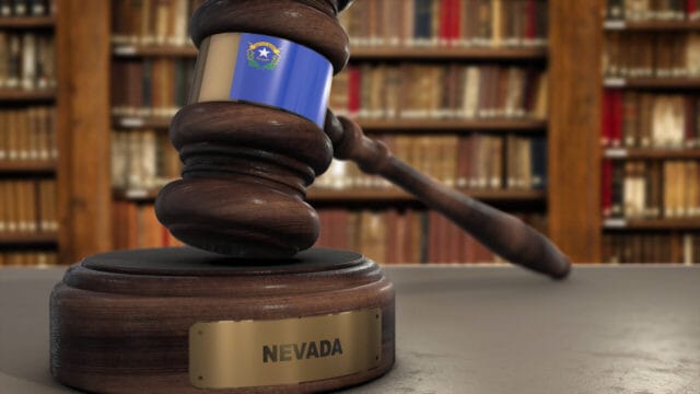 Wooden gavel with a Nevada nameplate on its sounding block in a law library
