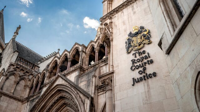 Ornate gothic law courts building facade against a blue sky