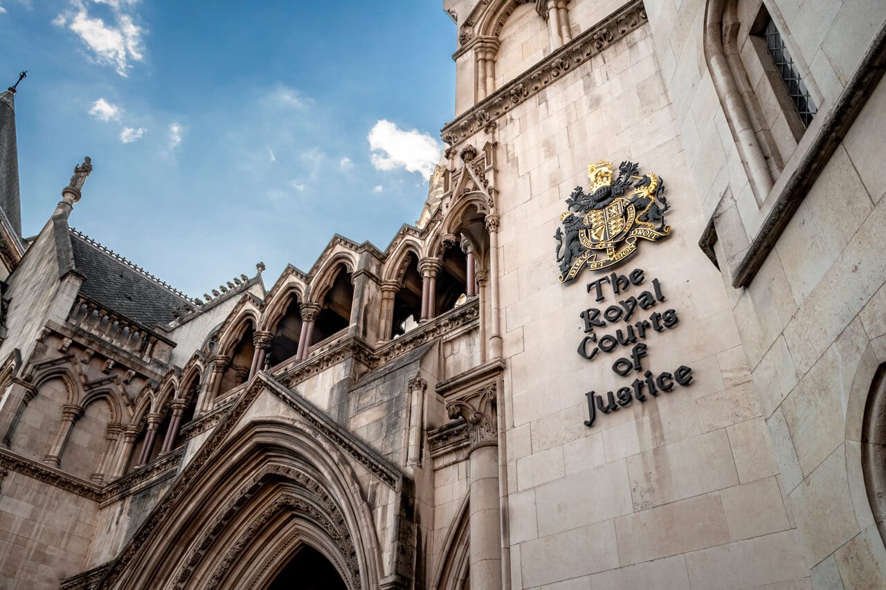 Ornate gothic law courts building facade against a blue sky