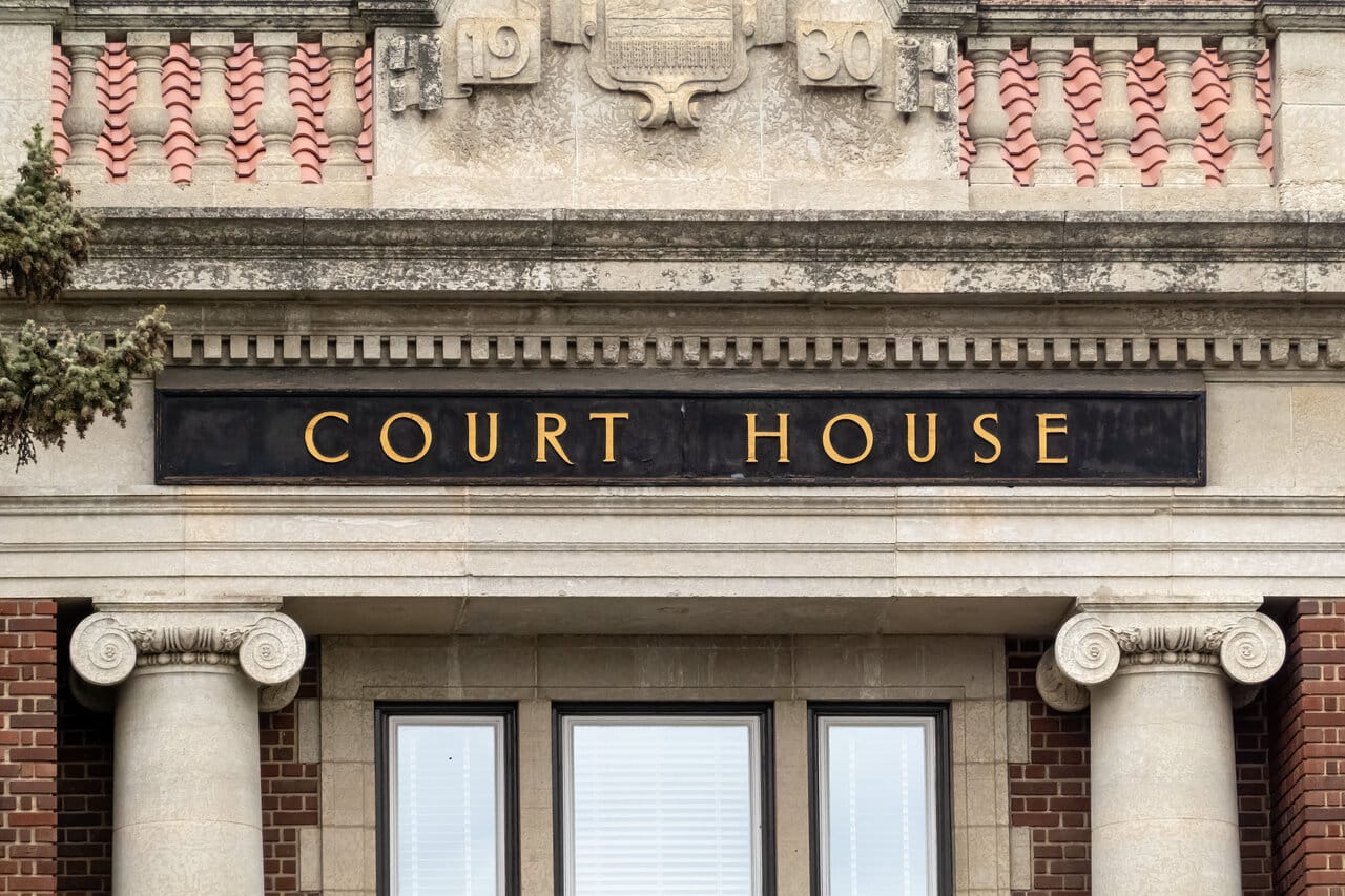 Stone courthouse facade with carved Court House lettering above classical columns