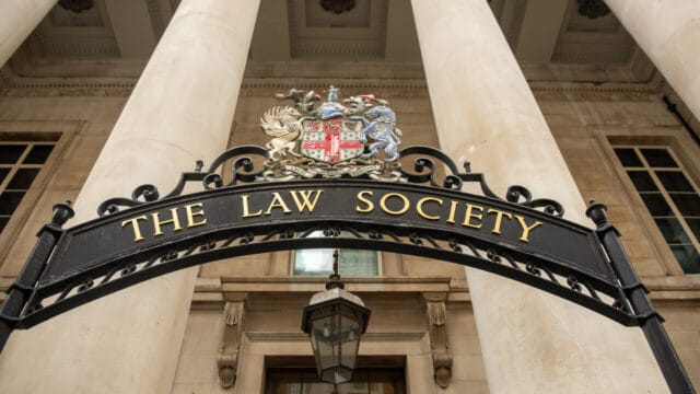 Wrought-iron Law Society arch over the entrance of a stone building