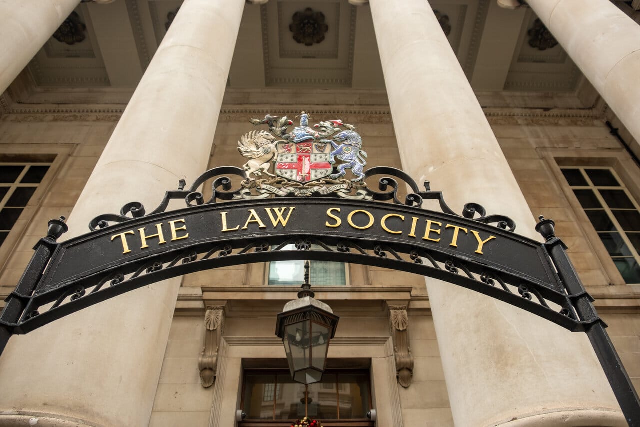 Wrought-iron Law Society arch over the entrance of a stone building