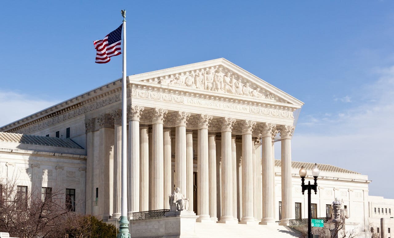 United States Supreme Court building with the American flag flying in front