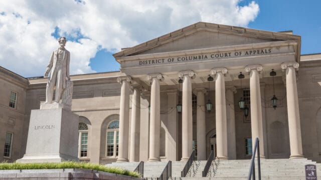 Neoclassical District of Columbia Court of Appeals building with a statue in front